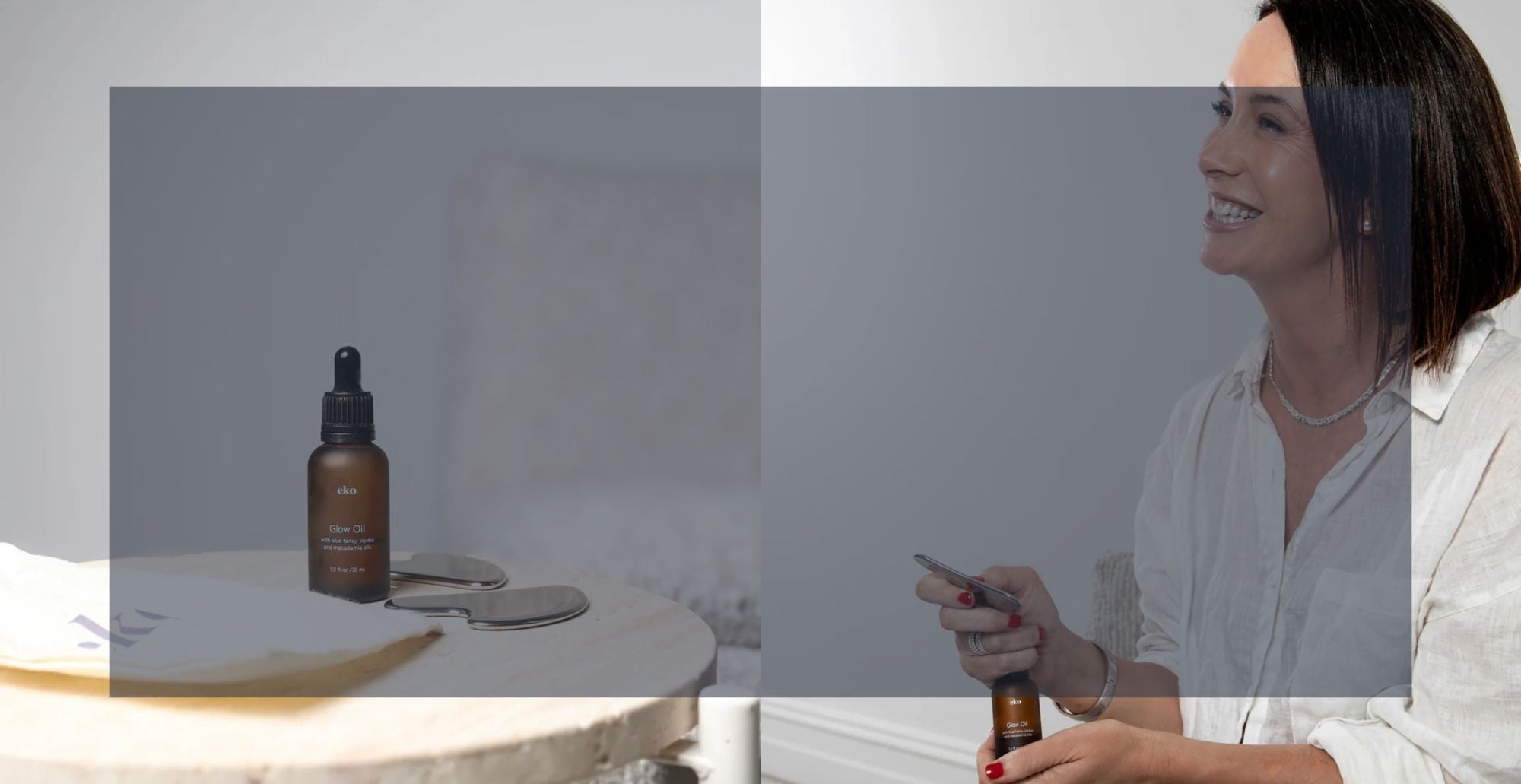 Woman holding a bottle of skincare product with a blurred background